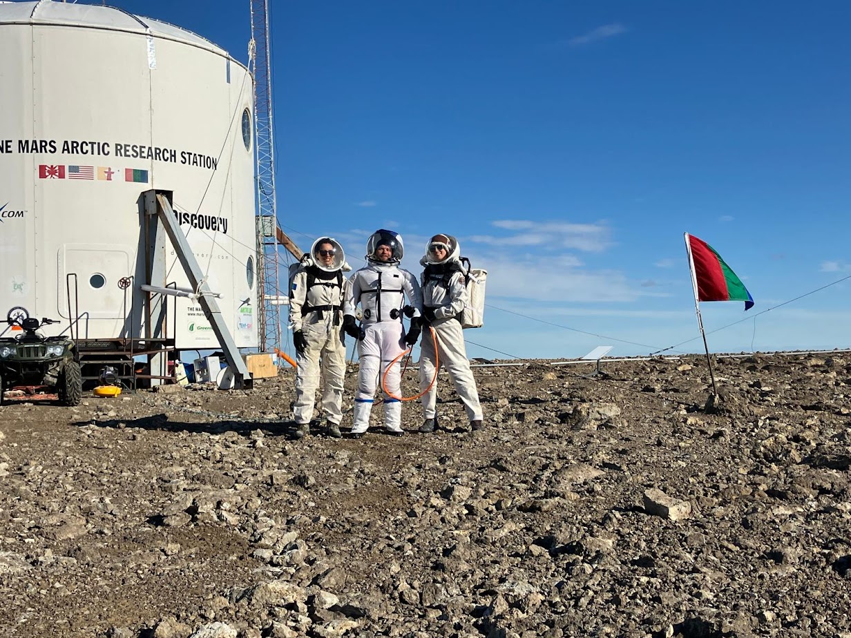 https://www.marssociety.org/wp-content/uploads/2024/07/FMARS-2024-1st-eva-three-crew-outside-hab.jpg?utm_source=chatgpt.com
